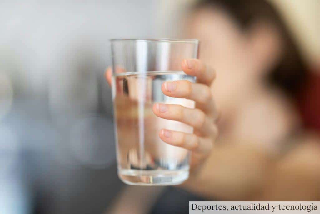 person holding clear drinking glass